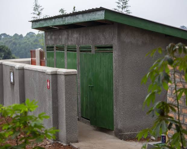 Toilet block with separate stalls and roofed access path.